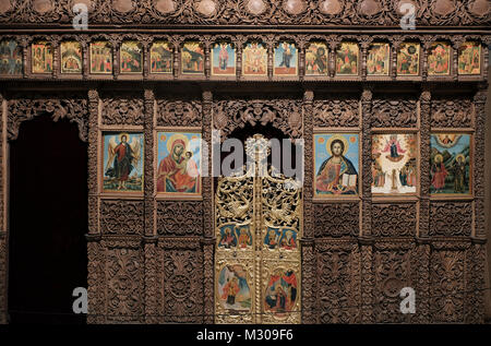 An old wooden iconostasis with icons and religious paintings displayed at the Alexander Nevsky Crypt Museum which houses the largest collection of Orthodox icons in Europe from the 13th to the 19th century located at the crypt of the Bulgarian Orthodox Saint Alexander Nevsky Cathedra in the city of Sofia capital of Bulgaria. Stock Photo