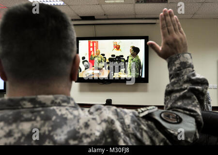 Lt. Col. Michelle Letcher, the 18th Combat Service Support Bn commander administers the Oath of Office to newly promoted Lt. Col. John Schoener a resident of Uniontown, Pa. and a member of the 316th Sustainment Command (Expeditionary), from Kandahar, Afghanistan. (US Army Photo) 121009-A-XD571-015 by 316th ESC Stock Photo