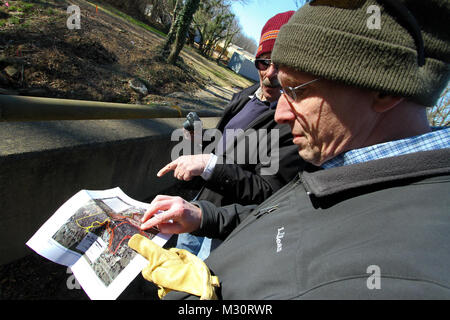 ARLINGTON, Va. -- Stephen Van Hoven, Arlington National Cemetery’s Horticulture Division chief, points to a map referencing  the area of land which will remain untouched and outside the boundaries of the Arlington National Cemetery Millennium Project here, Feb. 6, 2013. The Millennium Project will expand the cemetery by 27 acres, providing additional space and extending the ability to bury the nation’s military heroes from 2025 to 2045. 130206-A-OI229-072 by norfolkdistrict Stock Photo