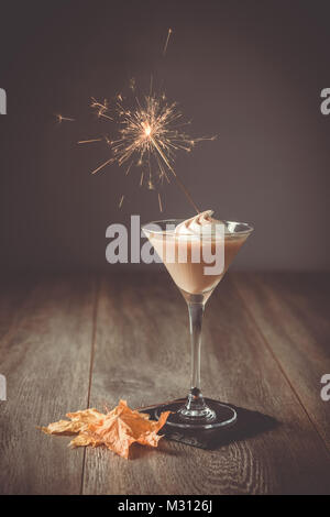 Irish cream liqueur on bonfire night with sparkler Stock Photo