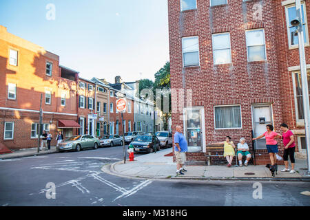 Baltimore Maryland,Little Italy neighborhood row house,brick,man men male,woman female women,neighbor,sit on street,sidewalk,visiting,talking,conversa Stock Photo