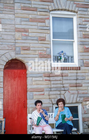 Baltimore Maryland,Little Italy neighborhood,working class row house,woman female women,neighbor,sitting,bench,eating,senior seniors citizen citizens, Stock Photo