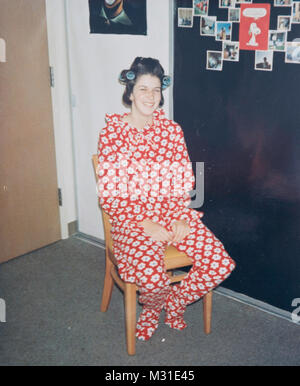Teenager with Rollers in her Hair Wearing One-Piece Footed Pajamas