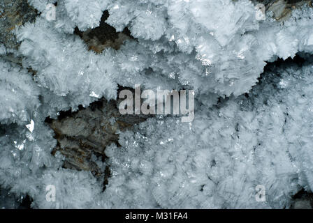 background: a section of the cave wall covered with large crystals of hoarfrost Stock Photo