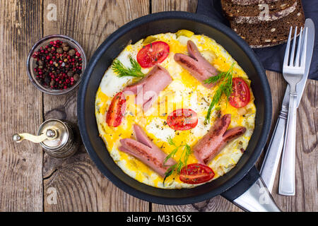 Breakfast for the family. Omelette with sausages Stock Photo