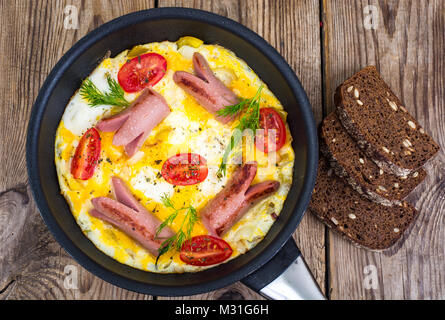 Breakfast for the family. Omelette with sausages Stock Photo