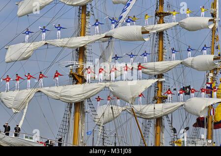 Amsterdam, the Netherlands - August 23, 2015: Sailors of the ARC Gloria tall ship (Colombia) standing on the masts during the SAIL 2015 event Stock Photo