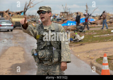 Oklahoma Army National Guardsman, Sgt Joseph Sisco with Headquarters Company, 1st Battalion, 179th Infantry, 45th Infantry Brigade Combat Team, Gives direction to members of his communicty presence patrol team. Community presence patrols provided assistance to residents of Moore, Okla., who were affected by the May 20th, 2013,  F5 tornado which tore through the community, leaving a path of devistation up to a mile wide and 18 miles long.  (U.S. Air National Guard photo by Master Sgt. Mark Moore/Released) Community Presence Patrols 001 by Oklahoma National Guard Stock Photo