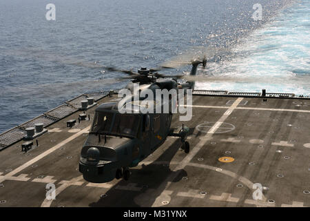 SOUTH CHINA SEA (June 18, 2013) A Royal Malaysian Navy Super Lynx lands on the flight deck of USS Freedom (LCS 1) during deck landing qualifications (DLQs). The Super Lynx, call sign RENTAP, is the first foreign helicopter to ever land on Freedom. Freedom is in Malaysia participating in Cooperation Afloat Readiness and Training (CARAT) 2013. CARAT is a series of bilateral military exercises between the U.S. Navy and the armed forces of Bangladesh, Brunei, Cambodia, Indonesia, Malaysia, the Philippines, Singapore, Thailand and Timore Leste. (U.S. Navy photo by Mass Communication Specialist 1st  Stock Photo