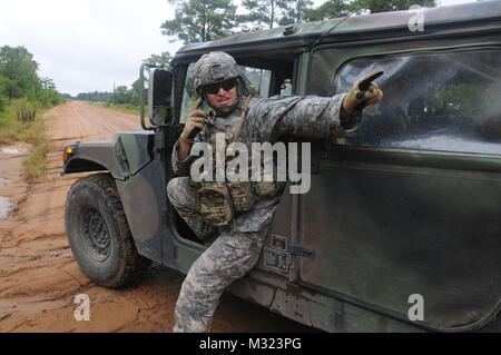 48th Infantry Brigade XCTC GEORGIA GARRSON TRAINING CENTER, Fort Stewart, Ga. Sept. 22, 2013 –  Sitting in a humvee using the radio, Georgia Army National Guardsman Sgt. Kyle Black, a convoy commander with Charlie Company, 2nd Battalion, 121st Infantry, sets up a hasty defensive position while directing vehicles in his resupply convoy which are in route to provide support to objective “Cobra” during eXportable Combat Training Capabilities (XCTC) training at Fort Stewart. Black is a Buford, Ga., native. He is a full-time student at Liberty University studying business management. He has been in Stock Photo