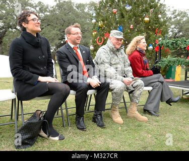 From right to left, State Representative Donna Howard, Maj. Gen. William L. Smith, Deputy Adjutant General for the Army and Commander of the Texas Army National Guard, Jeff Brooks, Texas Governor's Office Advisor, and Anna deFrates, District Director for State Senator Kirk Watson, sing Christmas Carols at the annual Texas Military Force Christmas Tree lighting event held on Camp Mabry in Austin, Texas, Dec. 6, 2013. (U.S. Army National Guard photo by Staff Sgt. Malcolm McClendon). TXMF Tree Lighting Ceremony by Texas Military Department Stock Photo