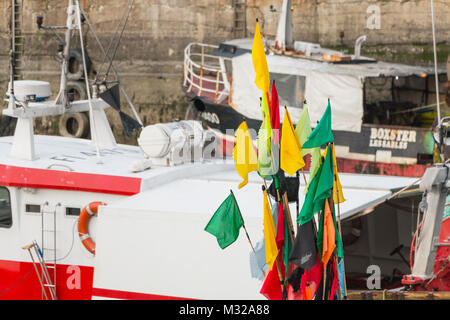 Sables d Olonne, France - March 16, 2017 : closeup of flags hung on floats on fishing boats near starting at the end of winter Sables d Olonne, France - March 16, 2017 : closeup of flags hung on floats on fishing boats near starting at the end of winter