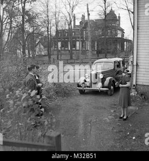 Sericeman and girl have picture taken outside the house in Nova Scotia, ca. 1938. Stock Photo