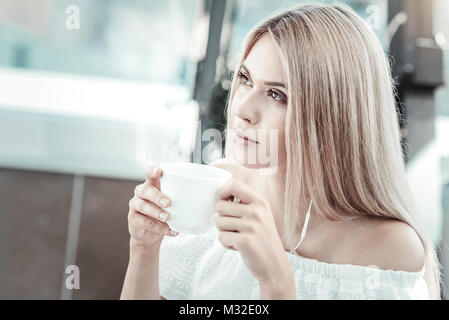 Attractive young woman having coffee Stock Photo