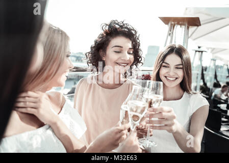 Positive nice women having champagne Stock Photo