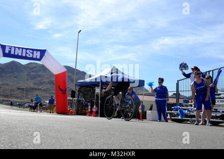 Air Force Wounded Warrior staff members, volunteers and athletes cheer on a cycling competitor during the 2016 Air Force Trials at Nellis Air Force Base, Nev., Feb. 27. The Air Force Trials are an adaptive sports event designed to promote the mental and physical well-being of seriously wounded, ill and injured military members and veterans. More than 100 wounded, ill or injured service men and women from around the country will compete for a spot on the 2016 Warrior Games Team which will represent the Air Force at the US Military Academy at West Point in June. (U.S. Air Force photo by Staff Sg Stock Photo