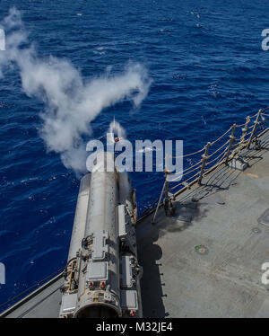 WATERS NEAR GUAM (Mar. 07, 2016) The Arleigh Burke-Class guided-missile destroyer USS McCampbell (DDG-85) fires an MK-54 exercise torpedo (EXTORP) over the port side during an anti-submarine warfare (ASW) event as part of MULTI SAIL 2016. MULTI SAIL is a bilateral training exercise aimed at interoperability between the U.S. and Japanese forces. This exercise builds interoperability and benefits from realistic, shared training, enhancing our ability to work together to confront any contingency. McCampbell is on patrol in the 7th fleet of operations in support of security and stability in the In Stock Photo