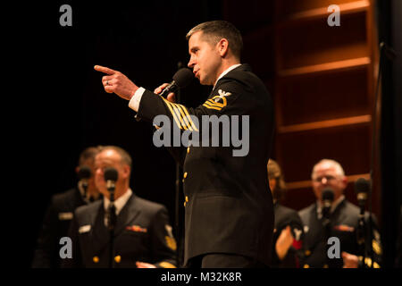 EDINBORO, PA (April 5, 2016) Chief Musician Adam Tyler sings with the United States Navy Band Sea Chanters chorus during a concert at Edinboro University. The Sea Chanters are on a 22-day tour of the northeastern United States. (U.S. Navy photo by Chief Musician Melissa Bishop/Released) 160405-N-NW255-098 by United States Navy Band Stock Photo