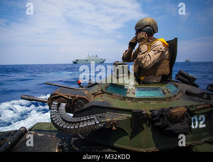 160718-M-OI464-127 Pacific Ocean – Cpl. Ryan Dills communicates with other assault amphibious vehicles while traveling from amphibious assault ship USS America to Royal Australian Navy Canberra class amphibious ship HMAS Canberra (L02). The Marines are participating in the Rim of the Pacific (RIMPAC) 2016, a multinational military exercise, from June 29 to Aug. 4 in and around the Hawaiian Islands. Participation in RIMPAC will help us develop mutual trust and respect across the joint and combined team through increased understanding of allied and partner cultures, competencies, and capabilitie Stock Photo