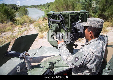 A soldier from the 36th Infantry Division, Texas Army National Guard, operates specialized equipment at the Texas-Mexico border. The soldier is serving in support of Operation Strong Safety. (U.S. Army photo by Maj. Randall Stillinger) 140824-A-AF730-014 by Texas Military Department Stock Photo