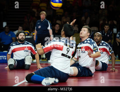 Retired U.S. Army Staff Sgt. Derrick David (center) tracks the ball for a hit during sitting volleyball at the 2014 London Invictus Games, Copper Box Athletic Centre, England, Sept 14, 2014. Prince Harry was driven to bring the event to an international audience following his inspirational visit to the Warrior Games in Colorado in 2013. The event in London will bring together for the first time servicemen and women – both serving and veteran – from 14 nations. The Invictus Games will spotlight the sacrifices these men and women made serving their country, and their indefatigable drive to overc Stock Photo