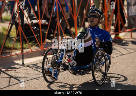 U.S. Air Force athlete Christopher Aguilera finishes a recumbent cycling race September 29, 2014 at Fort Carson, Colorado. The Warrior Games consists of athletes from throughout the Department Of Defense, who compete in paralympic style events for their respective military branch. The goal of the games is to help highlight the limitless potential of warriors through competitive sports. (U.S. Air Force photo by Airman 1st Class Taylor Queen) 140929-F-SP601-229 by Air Force Wounded Warrior Stock Photo