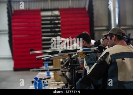 Orion Orellana, Air Force Wounded Warrior athlete, looks down the sights of an air rifle during the Air Force Wounded Warrior Trials marksmanship competition on Nellis Air Force Base, Nev., April 11, 2014. The Wounded Warrior Air Force Trials is a sports event designed to promote the mental and physical well-being of seriously ill and injured military veterans. More than 130 injured service men and women from around the country complete for a spot on the 2014 U.S. Air Force Wounded Warrior Team. (U.S. Air Force photo/Senior Airman Cory D. Payne) 140411-F-WJ663-075 by Air Force Wounded Warrior Stock Photo