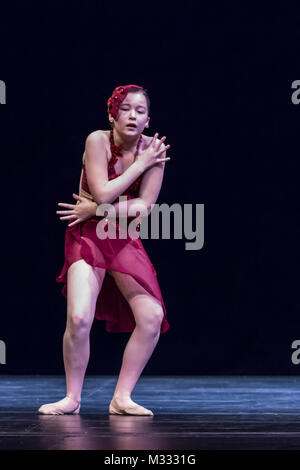 Twelve year old girl performing a solo lyrical dance onstage, conveying sadness and grief Stock Photo