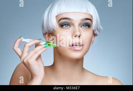 Beautiful woman with syringe making rejuvenate injection. Clean Beauty concept Stock Photo