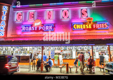 Philadelphia Pennsylvania,South Philly,South 9th Street Geno's restaurant food dining,customers families roast pork cheese fries neon signs night Stock Photo