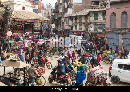 Kathmandu, Nepal - December 20 2017: Traffic of cars, rickshaws and people move in the chaotic streets of Kathmandu at the Indra Chowk intersection in Stock Photo