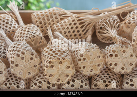 Close up stack or row of brown round bamboo market in wooden tray. Stock Photo