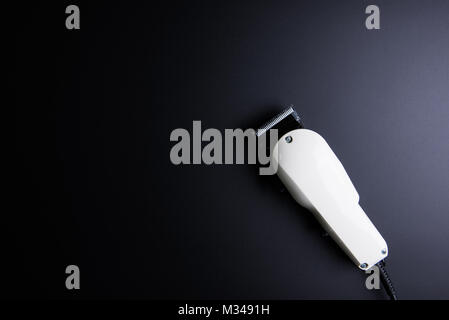 White electric clippers barber on black background. Hairdresser salon concept, Hairdressing Set. Haircut accessories. Copy space image, flat lay Stock Photo