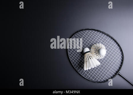 Two shuttlecocks and badminton racket on black background.Sport concept, Copy space image for your text Stock Photo