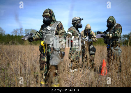 PERRY, GA - Air National Guard Emergency Managers search for radioactive material during a Global Dragon training event at the Guardian Center of Georgia on March 15, 2015.    During this day's training, airmen searched for material following a simulated aircraft crash in a deployed location. Students wore Mission Oriented Protective Posture (MOPP) 4 gear, and used Gieger Counters to search through an empty field for the lost material.   Global Dragon provides a refresher course for Airmen, allowing them to put their skills to use to identify live chemical, biological, radiological and nuclear Stock Photo