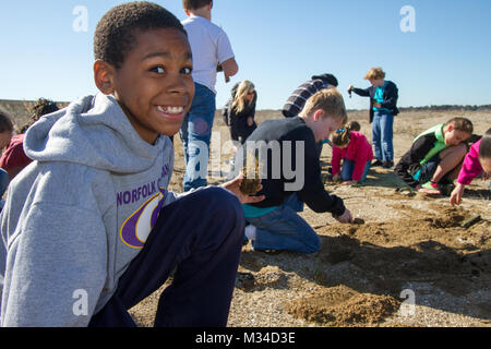 PORTSMOUTH, Va. -- Shane Richardson, a fourth grade student at the Norfolk Christian School, plants Spartina patens at the Craney Island Dredged Material Management Area here March 31, 2015. As part of its STEM outreach program, the district partnered with the Elizabeth River Project, which oversaw the event and provided a place for students to plant marsh grasses and learn about the diverse ecosystem along the shoreline of the Elizabeth River. (U.S. Army photo/Patrick Bloodgood) 150331-A-OI229-012 by norfolkdistrict Stock Photo