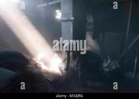 Jixi, Heilongjiang, China. 4th July, 2017. A worker covered in graphite dust inside a warehouse where graphite is processed. Graphite is a key component in the batteries that power electric cars. Credit: Dave Tacon/ZUMA Wire/ZUMAPRESS.com/Alamy Live News Stock Photo