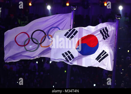 Pyeongchang, South Korea. 9th Feb, 2018. The Olympic flag and South Korea's national flag blowing in the wind at the opening ceremony of the 2018 Winter Olympics in Pyeongchang, South Korea, 9 February 2018. Credit: Daniel Karmann/dpa/Alamy Live News Stock Photo