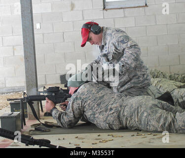 Staff Sgt. Jeff DeClercq works with a fellow Airman at the rifle marksmanship range at Selfridge Air National Guard Base, Mich., Feb. 4, 2018. The Citizen-Airmen of the 127th Wing spent the February regularly scheduled drill focused on expeditionary skills training. Stock Photo