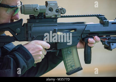 Cartridges fly out from an Heckler and Koch G36K A4 rifle, on Chièvres Air Base, Belgium, Jan. 24, 2018. (U.S. Army photo by Visual Information Specialist Pierre-Etienne Courtejoie) Stock Photo