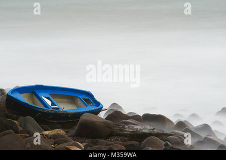 10 Stop Neutral Density Long Exposure Photograph of boat on rocks near Gulf of Pozzuoli, Naples, Italy