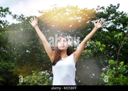 Young asian woman raise her hand up to resting after workout session Stock Photo