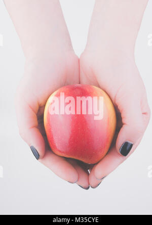 Apple in woman's hands Stock Photo