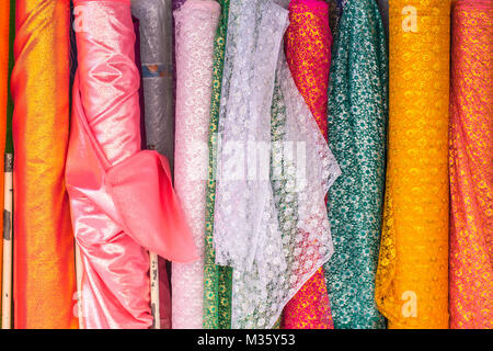 Thai Indian colorful fabric textile floral pattern roll cloth industry for sale. Stock Photo