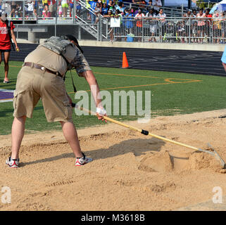 Pfc. Brady Hester, 22, of Nacogdoches, with the Texas Army National Guard's Recruit Sustainment Program volunteers at the boys long jump competition July 31, 2015, at the Texas Amatuer Athletic Federation's Summer Games in College Station. About 75 Texas Guard's RSP warriors and the TXARNG's Recruiting and Sustainment Command supported the annual, five-day sporting event that hosted hundreds of athletes from around the state. (Air National Guard photo by 1st Lt. Alicia M. Lacy/Released) 150731-Z-NC104-023 by Texas Military Department Stock Photo