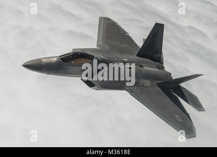 An F-22A Raptor from the 95th Fighter Squadron at Tyndall Air Force Base, Fla., flies over the Nevada Test and Training Range during Red Flag 15-3 at Nellis AFB, Nev., July 31, 2015. Red Flag gives aircrews and air support operations Service members from various airframes, military services and allied countries an opportunity to integrate and practice combat operations. (U.S. Air Force photo/Senior Airman Brittany A. Chase) 24480350084 bb692fe04a o by AirmanMagazine Stock Photo