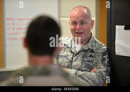 Air National Guard Chief Master Sgt. James W. Hotaling speaks with pararescue jumpers with the 103rd Rescue Squadron shortly before conducting his final jump from a military aircraft over FS Gabreski ANG on Sept. 2, 2015. During his visit with the 106th Rescue Wing, Hotaling will meet with junior and senior enlisted airmen to discuss their needs and any ongoing issues they may be facing. Hotaling is the 11th command chief master sergeant, Air National Guard. He represents the highest level of enlisted leadership for the Air National Guard. Hotaling is responsible for matters influencing the he Stock Photo