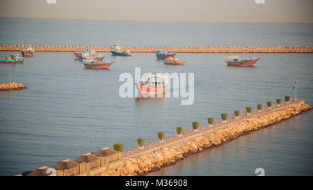 DUBAI, UAE - CIRCA 2008: Pan-left shot of boats docked at a seashore. Traditional fishing remains an important activity in the UAE. Stock Photo
