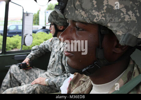 Louisiana National Guard high-water vehicle driver Sgt. Bryant Johnston of the 528th Engineer Company, a native of Bastrop, La., prepares to go on a search and rescue mission with Pvt. Stetson Thompson of Monroe, La., Aug. 16, 2016. The Louisiana National Guard continues to conduct response efforts, recovery missions, and preposition vehicles and assets in potentially affected areas, as directed by Gov. John Bel Edwards, since operations began, Aug. 12. (U.S. Army National Guard photo by Spc. Garrett L. Dipuma) La. Guard continues response, postures for future missions by Louisiana National Gu Stock Photo