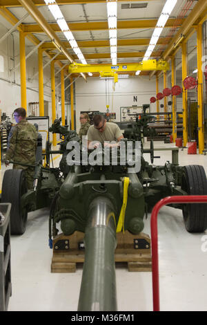 Spc. Tyler Hish, a small arms/artillery repairer with the Maine Army National Guard’s Forward Support Company, 133rd Engineer Battalion repairs an M777 Howitzer 82 as part of the company’s annual training at Camp Dodge, Iowa September 9-22, 2017. The small arms repairers performed maintenance, ordered new parts ,and disassembled and reassembled a variety of firearms their specialty is responsible for maintaining. “Iowa has a lot more resources than the state of Maine,” said Hish. “They have weapons that we don’t normally see and proper electronic technical manuals that we don’t always have acc Stock Photo